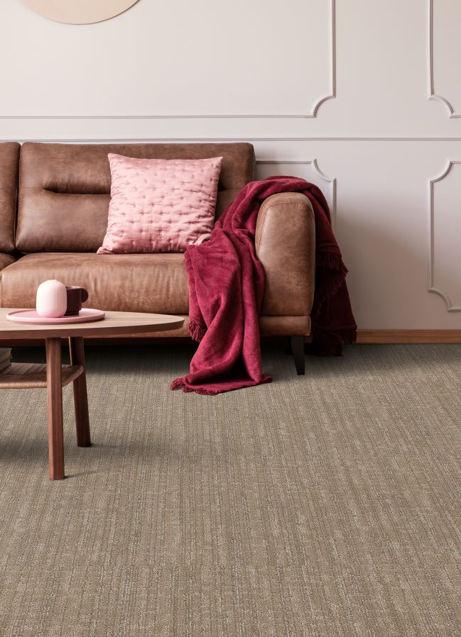 brown carpet in a stylish living room with leather couch and pink accents